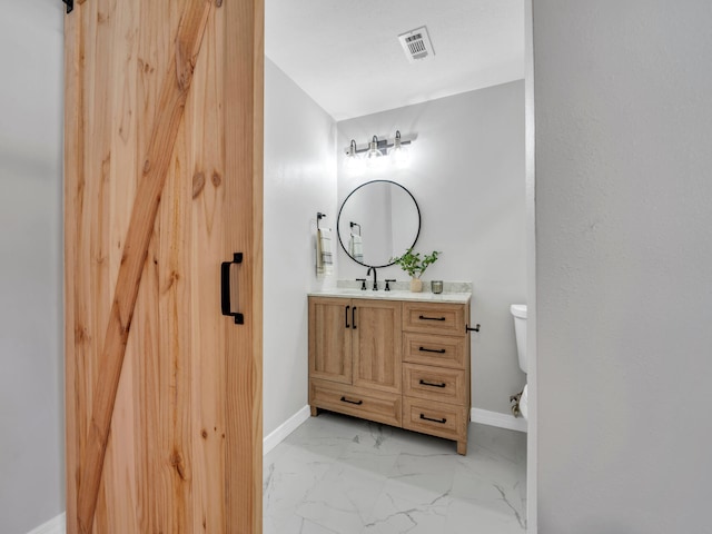 bathroom with vanity and toilet