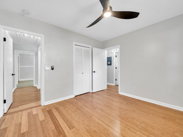 unfurnished bedroom with a closet, light hardwood / wood-style floors, and ceiling fan