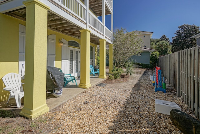 view of yard with a patio area and a balcony