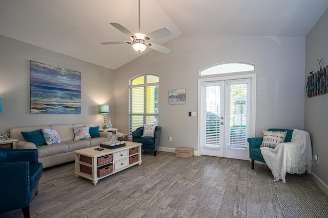 living room with lofted ceiling, hardwood / wood-style flooring, and ceiling fan