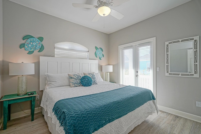 bedroom with wood finished floors, access to exterior, a ceiling fan, and baseboards