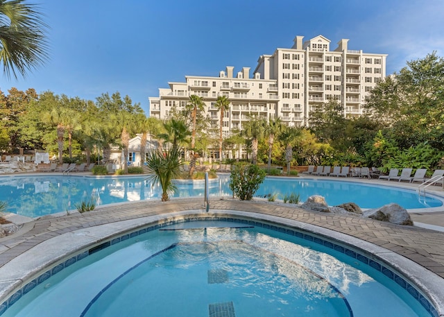 view of pool with a hot tub