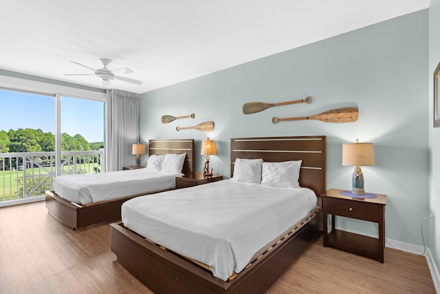 bedroom featuring ceiling fan, light hardwood / wood-style flooring, and access to outside