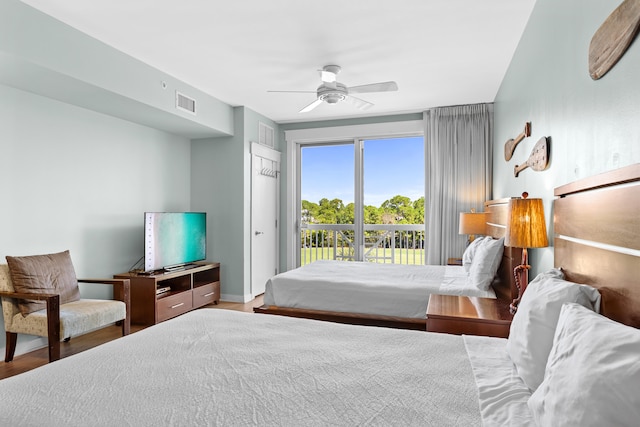 bedroom featuring access to outside, hardwood / wood-style floors, and ceiling fan