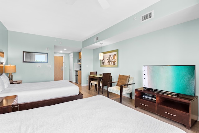 bedroom with ceiling fan and wood-type flooring