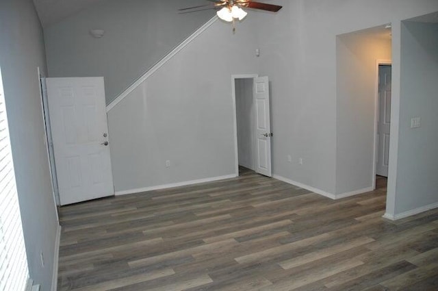 unfurnished living room with lofted ceiling, dark hardwood / wood-style floors, and ceiling fan