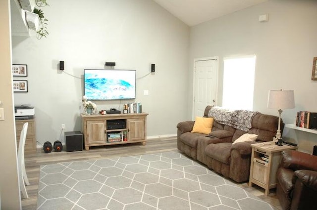 living room with light hardwood / wood-style flooring and high vaulted ceiling