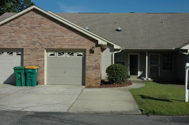 single story home featuring a front yard and a garage