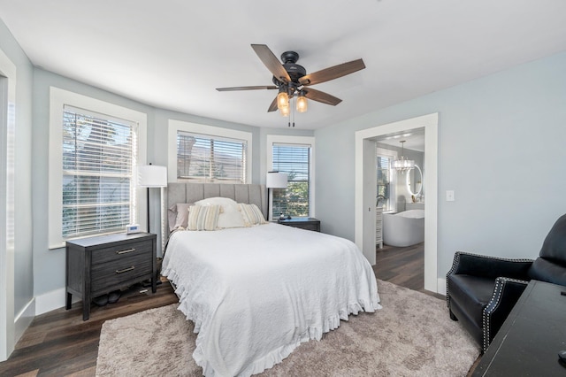 bedroom featuring ceiling fan with notable chandelier, ensuite bathroom, and dark wood-type flooring