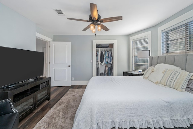 bedroom featuring dark wood-type flooring, a closet, and ceiling fan