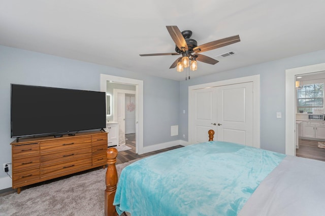 bedroom with ensuite bathroom, ceiling fan, a closet, and light hardwood / wood-style floors