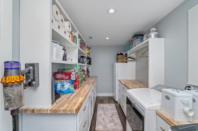 washroom featuring washing machine and clothes dryer and light hardwood / wood-style flooring