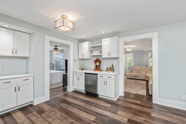 kitchen featuring plenty of natural light, stainless steel dishwasher, dark hardwood / wood-style floors, and white cabinets