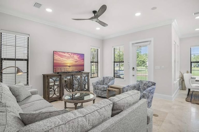 living room with ornamental molding, ceiling fan, and a wealth of natural light