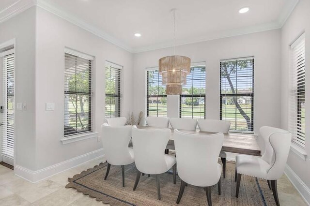 dining space featuring an inviting chandelier and ornamental molding