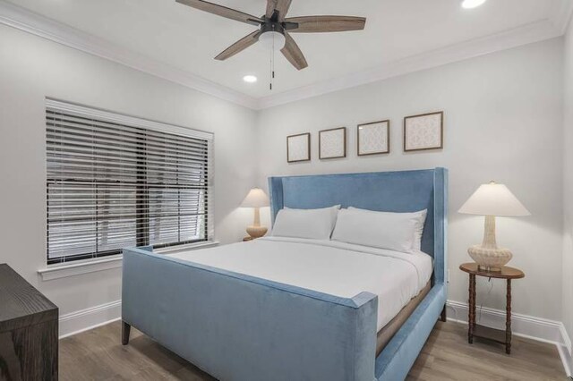 bedroom featuring ceiling fan, crown molding, and dark hardwood / wood-style flooring