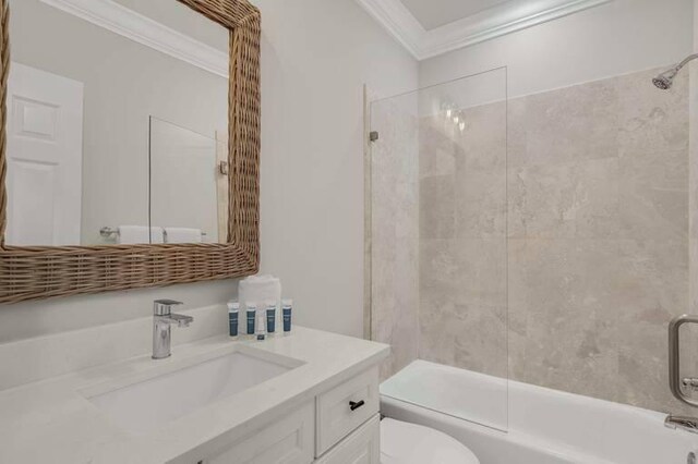 full bathroom featuring ornamental molding, shower / bath combination with glass door, toilet, and vanity