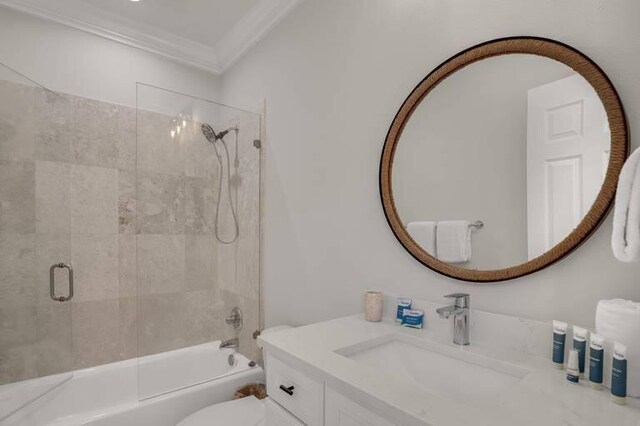 full bathroom with crown molding, shower / bath combination with glass door, vanity, and toilet