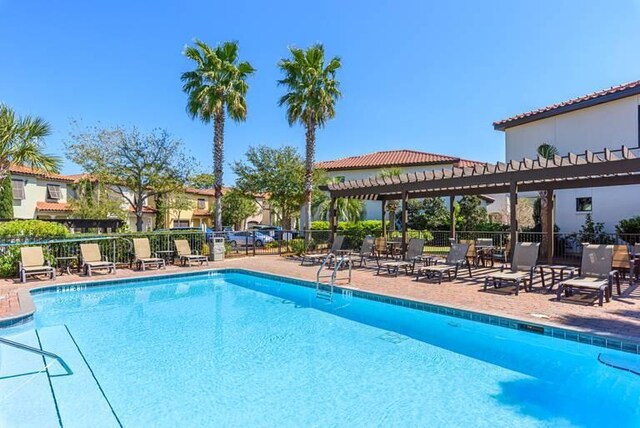 view of swimming pool featuring a pergola and a patio area