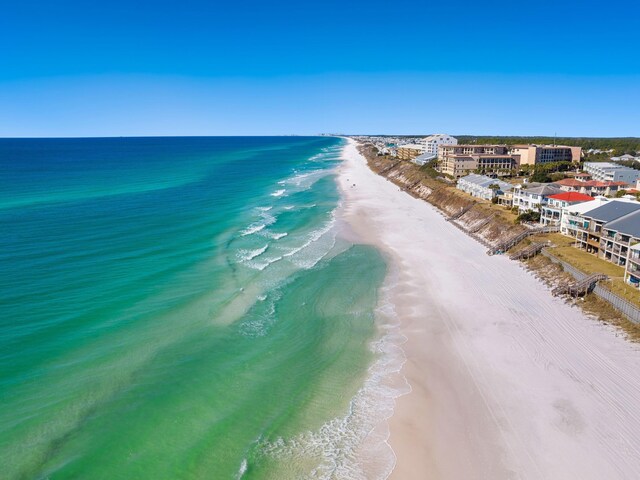 aerial view with a water view and a beach view