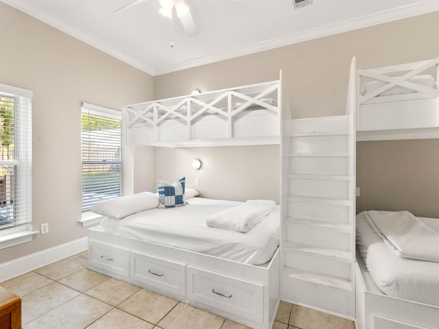 bedroom with ceiling fan, ornamental molding, and light tile patterned floors