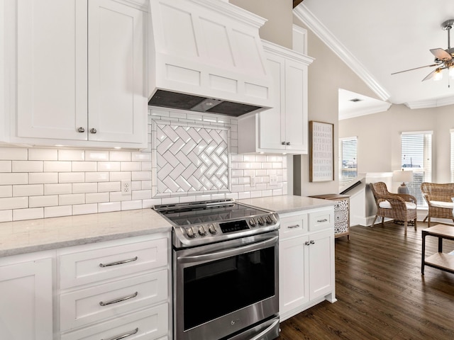 kitchen featuring stainless steel electric stove, white cabinets, crown molding, premium range hood, and dark hardwood / wood-style floors