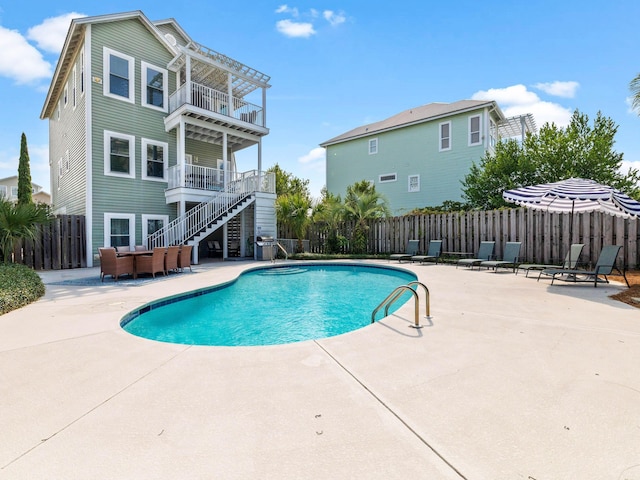 28 Sandcastle Ct, Santa Rosa Beach, FL 32459 - view of pool with stairway, a patio, a fenced in pool, and a fenced backyard