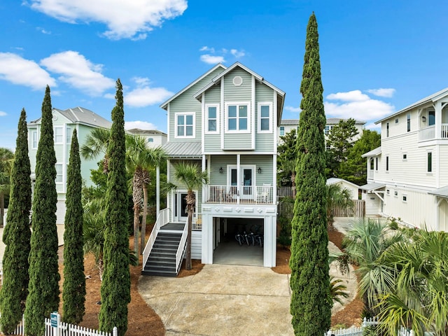 28 Sandcastle Ct, Santa Rosa Beach, FL 32459 - coastal inspired home with stairway, fence, covered porch, and driveway