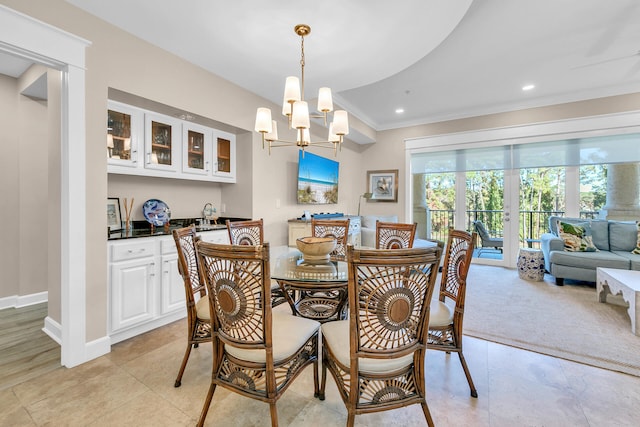 tiled dining space featuring crown molding and a notable chandelier