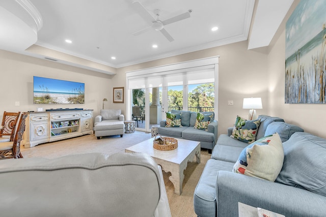 carpeted living room with ornamental molding and ceiling fan