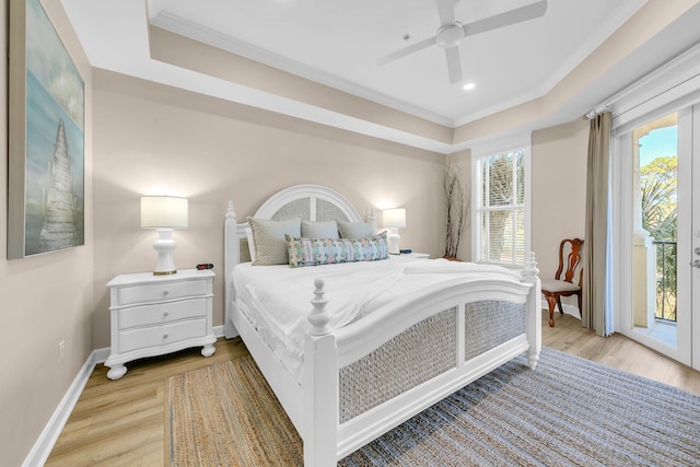 bedroom with a raised ceiling, ceiling fan, access to outside, light wood-type flooring, and crown molding