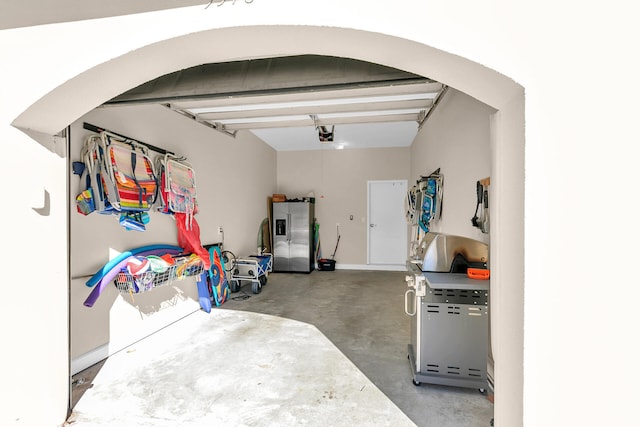 5378 Pine Ridge Ln Unit 5378, Miramar Beach, FL 32550 - garage featuring stainless steel fridge and a garage door opener