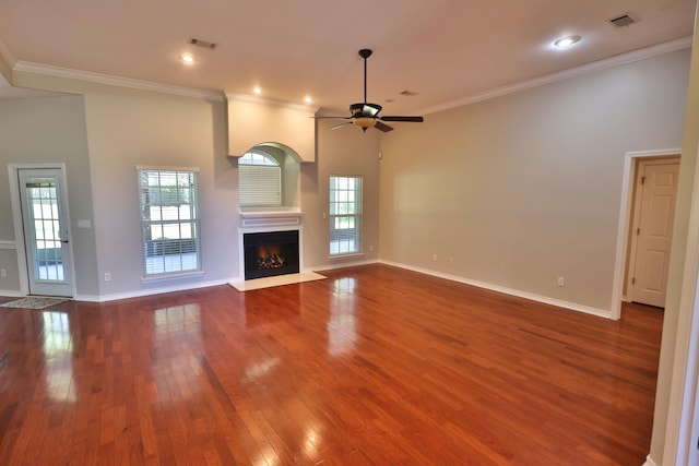 unfurnished living room with crown molding, ceiling fan, and dark hardwood / wood-style flooring