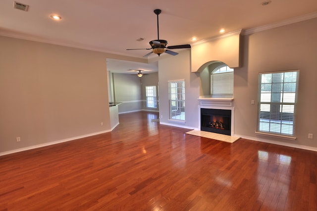 unfurnished living room with crown molding, ceiling fan, and wood-type flooring