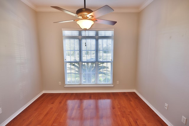 unfurnished room featuring hardwood / wood-style flooring, crown molding, and plenty of natural light