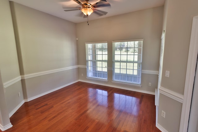 unfurnished room with ceiling fan and dark hardwood / wood-style flooring