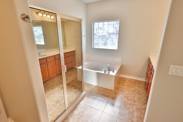 bathroom with shower with separate bathtub, tile patterned floors, and vanity