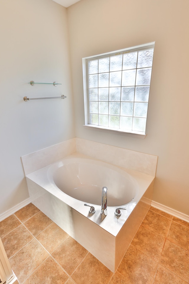 bathroom featuring tile patterned floors and tiled tub