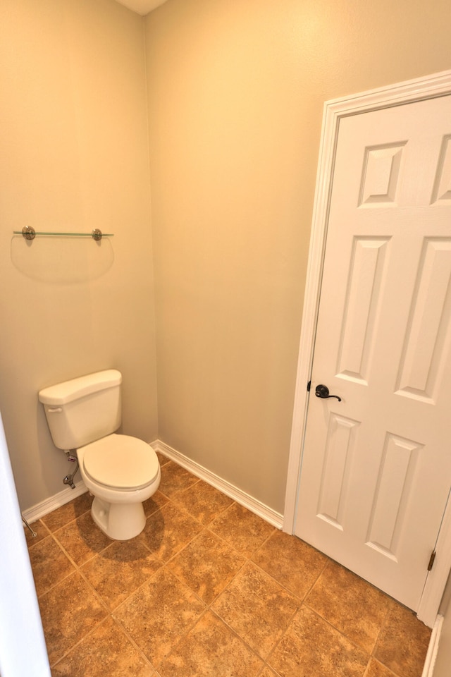 bathroom with tile patterned floors and toilet