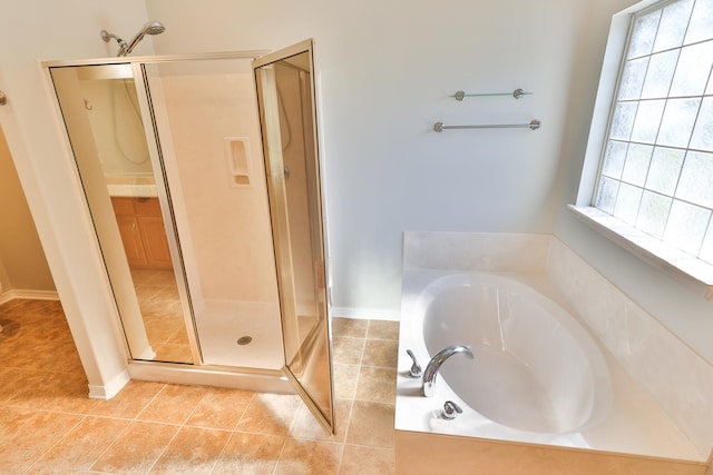 bathroom featuring plus walk in shower and tile patterned flooring