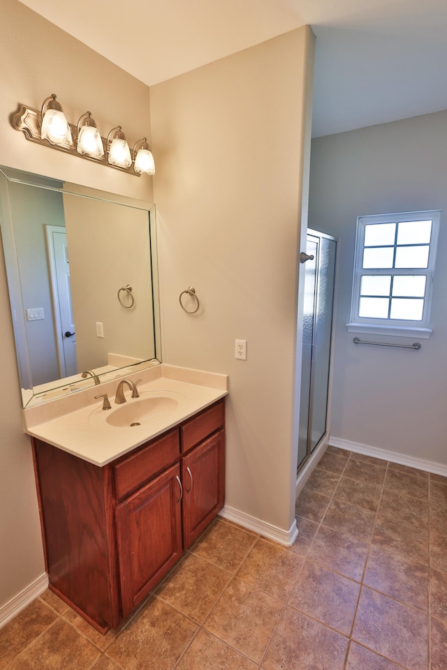 bathroom featuring walk in shower, vanity, and tile patterned floors