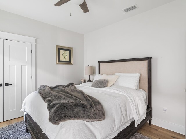 bedroom with dark hardwood / wood-style floors and ceiling fan