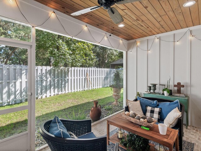 sunroom with ceiling fan and wood ceiling