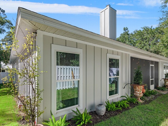 view of side of home with a sunroom