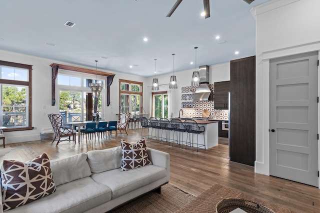 living room with crown molding and wood-type flooring