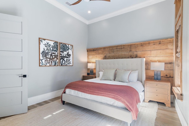 bedroom with ceiling fan, ornamental molding, and light wood-type flooring