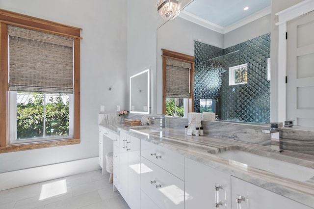 bathroom with vanity, crown molding, a tile shower, and tile patterned floors