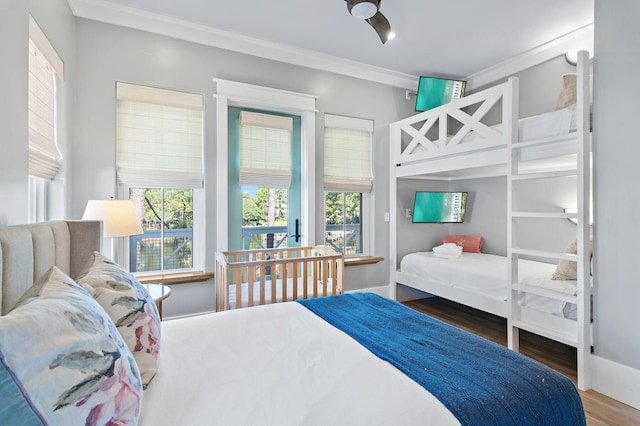 bedroom with ornamental molding and wood-type flooring