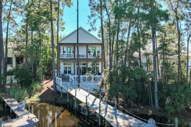 back of house with a water view and a balcony