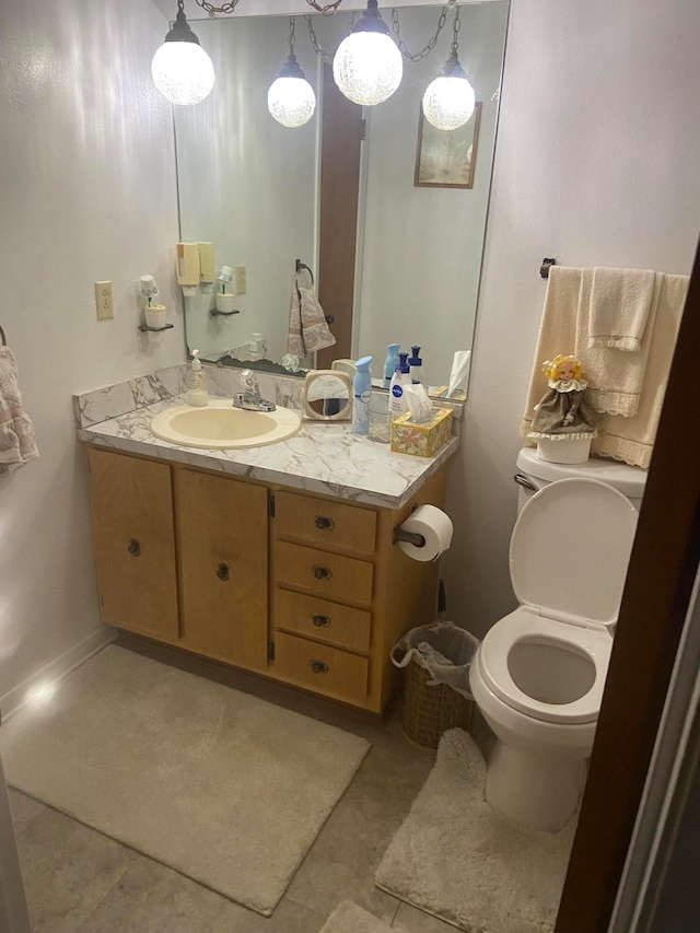 bathroom featuring toilet, vanity, and tile patterned floors